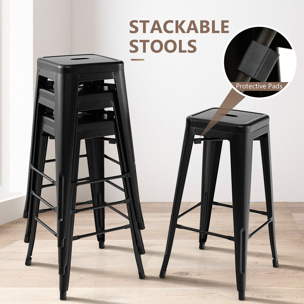 Stackable black bar stools set of 4 with square seats and handling holes, featuring non-slip foot pads for stability.