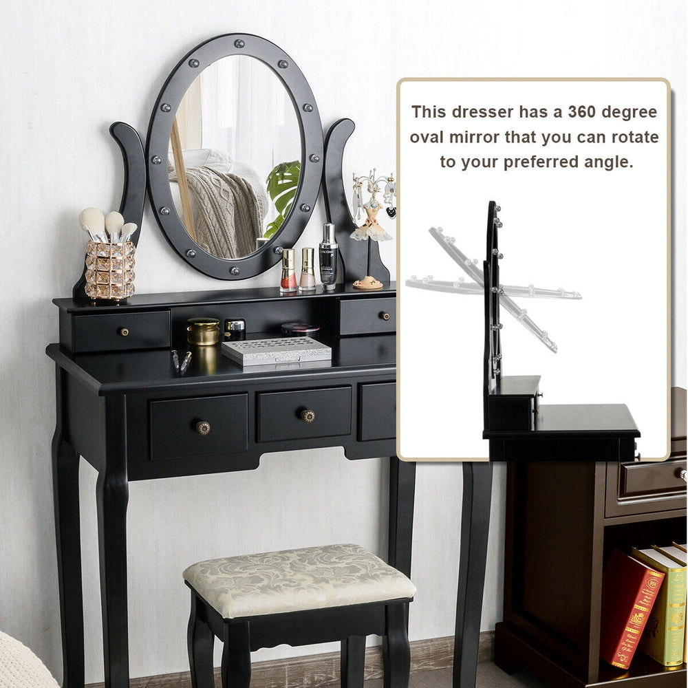 Black vanity table set with oval mirror, 12 LED bulbs, and cushioned stool, perfect for makeup and writing.