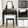 Vanity dressing table in black with 10 dimmable light bulbs, cushioned stool, and ample storage for cosmetics.