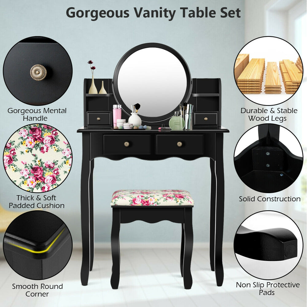 Black makeup vanity table set with oval mirror, 4 drawers, and cushioned stool for stylish and functional dressing.