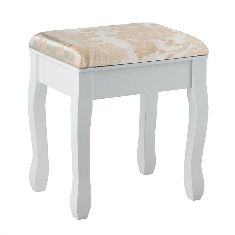 White padded stool with floral pattern, part of a makeup vanity set, providing comfort for beauty routines.