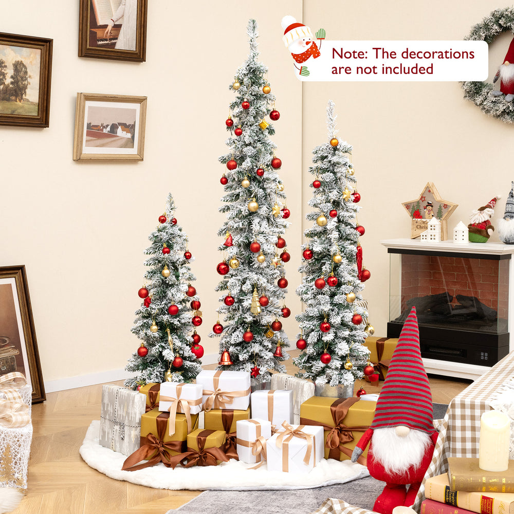 Set of 3 pre-lit snow flocked artificial Christmas trees with warm white LED lights, ideal for festive holiday decor.