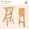 Set of 2 folding outdoor bar stools made from teak wood with ergonomic saddle seat and x-shaped frame for stability.
