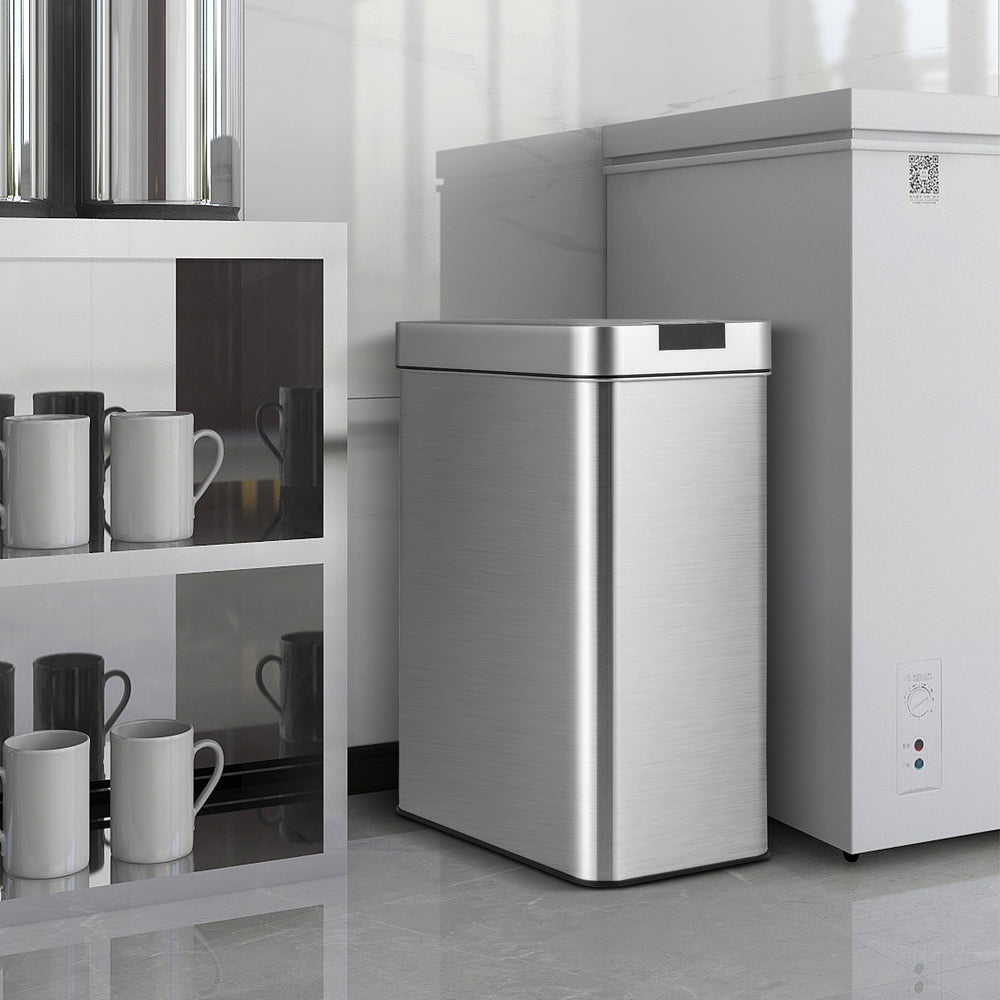 Slim kitchen trash can with wing lids, made of stainless steel, features soft-closing and infrared sensor for.
