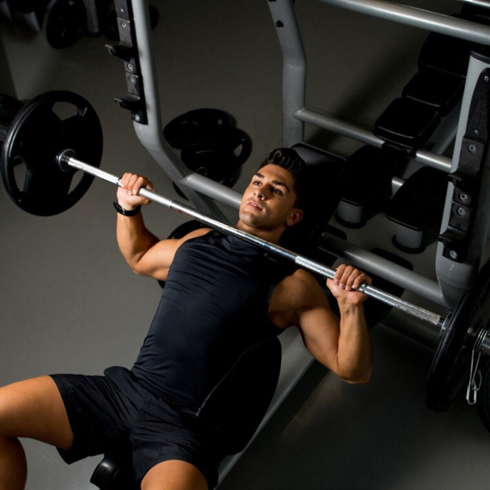 Weight lifting barbell with chrome finish and knurled handles, ideal for bench presses and heavy workouts.