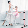 Side view of a pink portable ballet barre with adjustable height and anti-slip footpads, designed for safe dance.