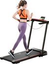 Folding treadmill with large desk and LCD display, showcasing a user walking indoors for fitness and convenience.