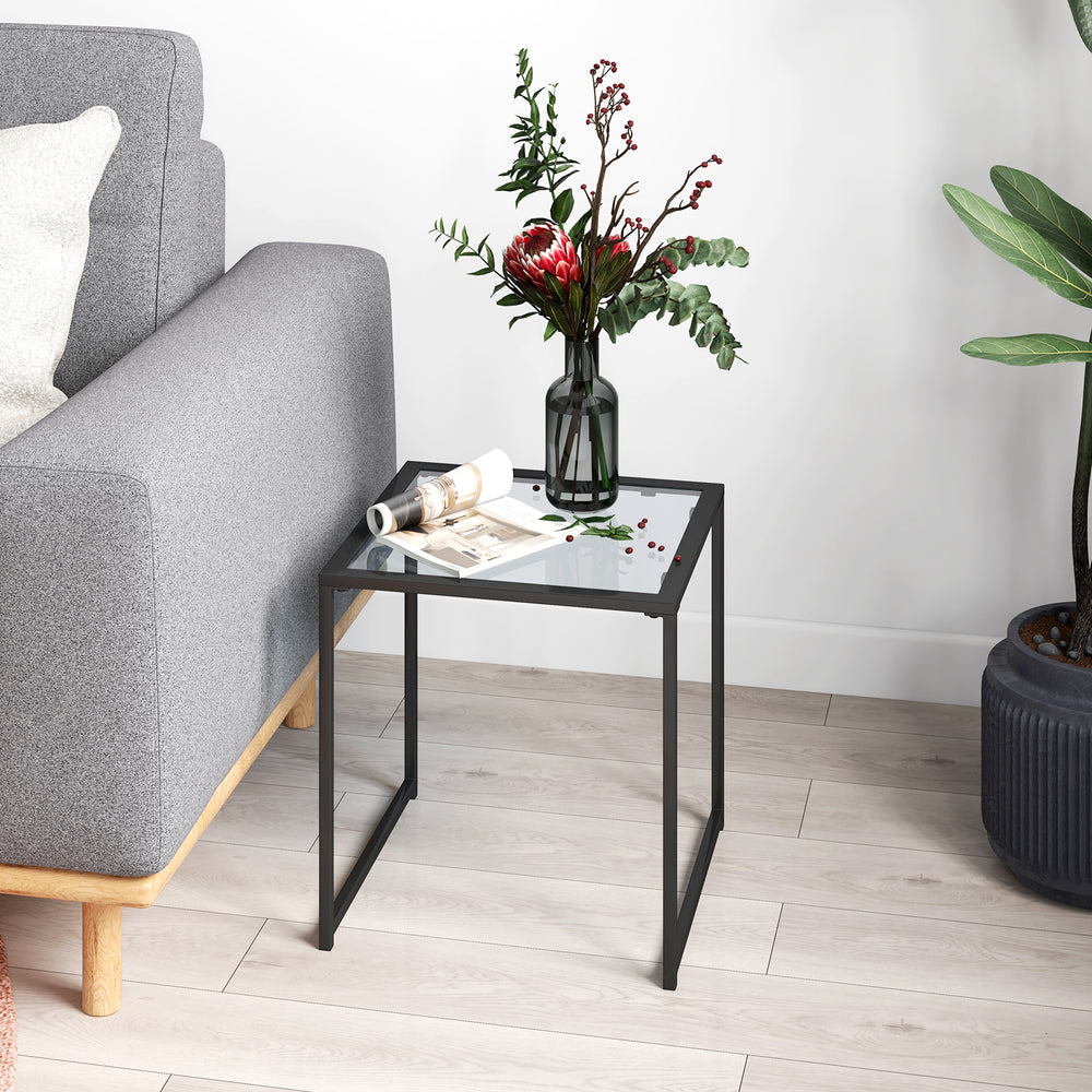 Square tempered glass side table with a sturdy metal frame, perfect for indoor or outdoor use, enhancing any space.