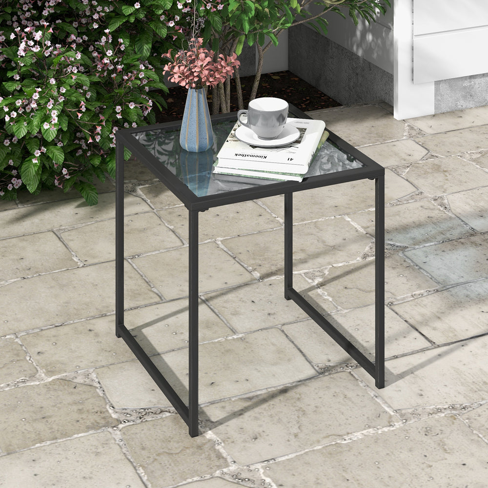 Square tempered glass side table with a powder-coated metal frame, stylish for balconies or poolside relaxation.