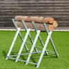Heavy duty portable foldable steel sawhorse supporting logs, designed for stability and easy transport.
