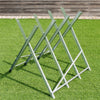 Heavy duty portable foldable steel sawhorse showcasing its sturdy triangular design, ideal for on-site woodworking.