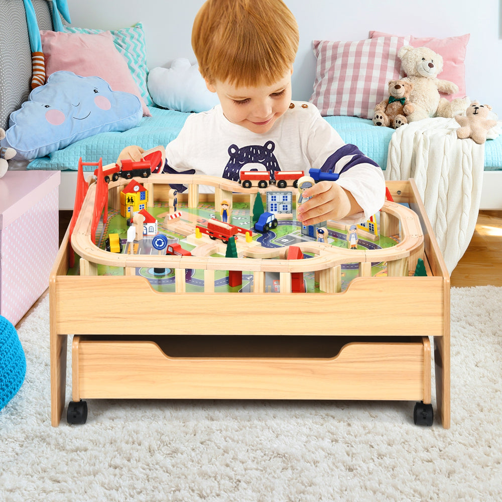 Kids wooden train set table with 100 colorful pieces, featuring lockable wheels and a storage drawer for organized play.