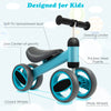 Baby balance bike in blue with 4 wide wheels, soft seat, and sturdy steel frame for toddlers aged 1-2 years.