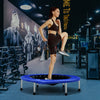 Mini folding trampoline in blue with a protective cover and strong springs, ideal for portable fitness workouts.
