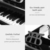 30-key black mini grand piano for children, crafted with eco-friendly paint, includes matching bench and music holder.