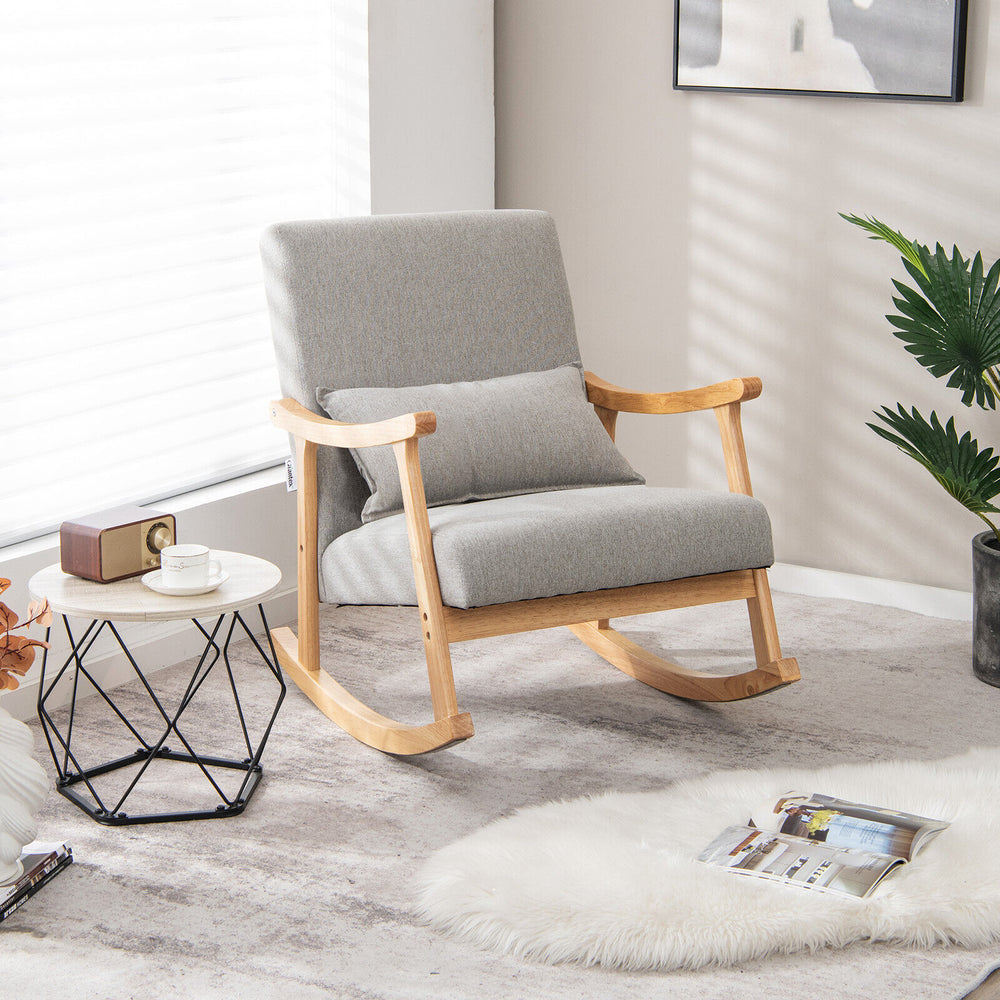 Upholstered rocking chair in gray with rubber wood frame and lumbar pillow, perfect for living room relaxation.