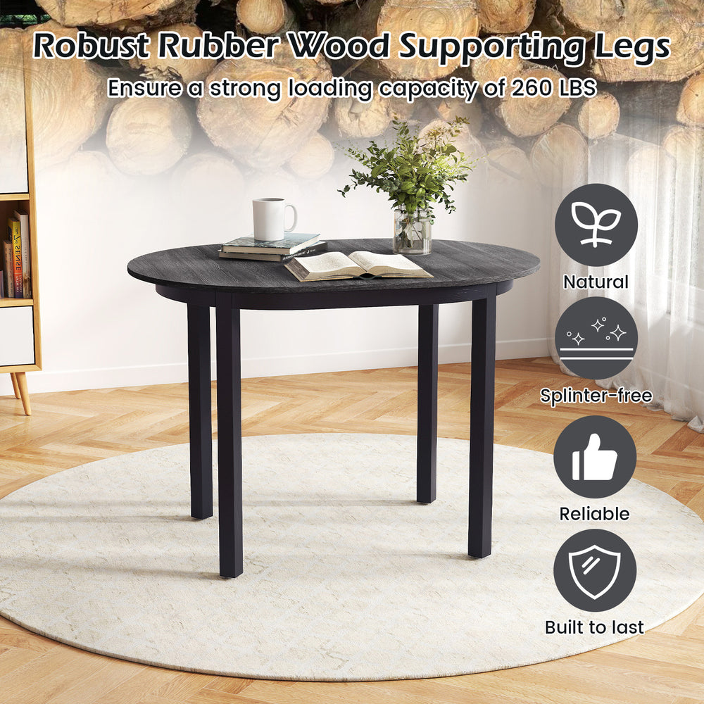 Detail of the sturdy rubber wood legs and smooth tabletop of the 43-inch black dining table, perfect for small spaces.