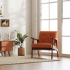 Accent chair in warm orange with wooden frame, featuring a tufted design for stylish living room seating.