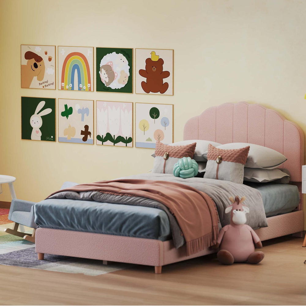 Twin pink bed with decorative pillows, blue and pink rocking chairs, and a white nightstand in a children's room.