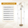 Three-globe floor lamp with a gold finish, providing warm lighting for a stylish bedroom setup.
