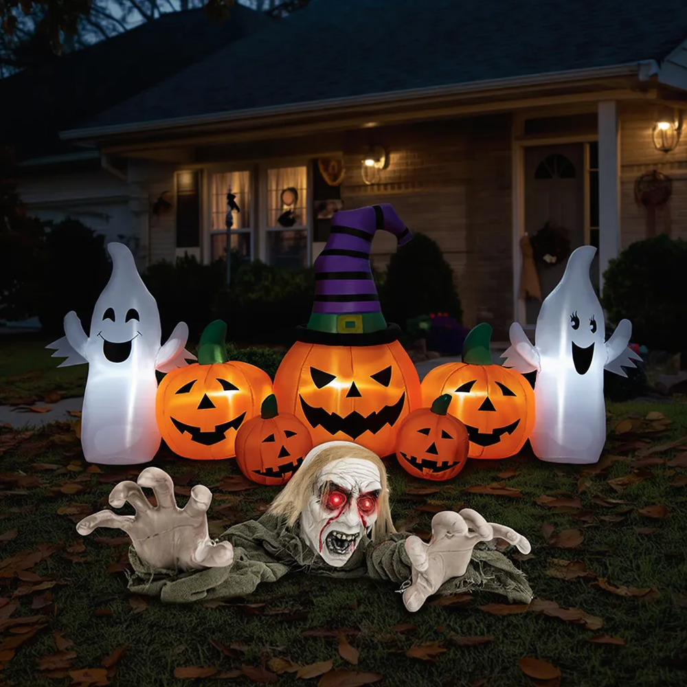 Life-size Halloween groundbreaker zombie with inflatable pumpkins and ghosts, perfect for yard decorations and parties.