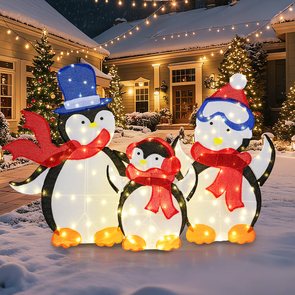 3-piece lighted penguin family decoration with 160 LED lights, featuring a dad, mom, and baby in red scarves for.