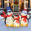 Lighted 3-piece penguin family Christmas decoration with 160 LED lights, featuring festive scarves for outdoor display.