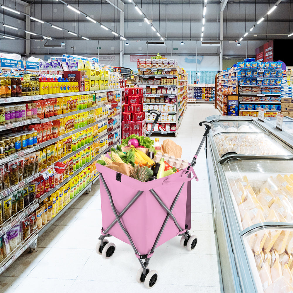 Folding shopping utility cart in pink with a water-resistant canvas bag, showcasing groceries in a supermarket aisle.