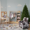 Kids room set featuring a black and white recliner, natural study desk, 4-ft Christmas tree, and dress-up storage.