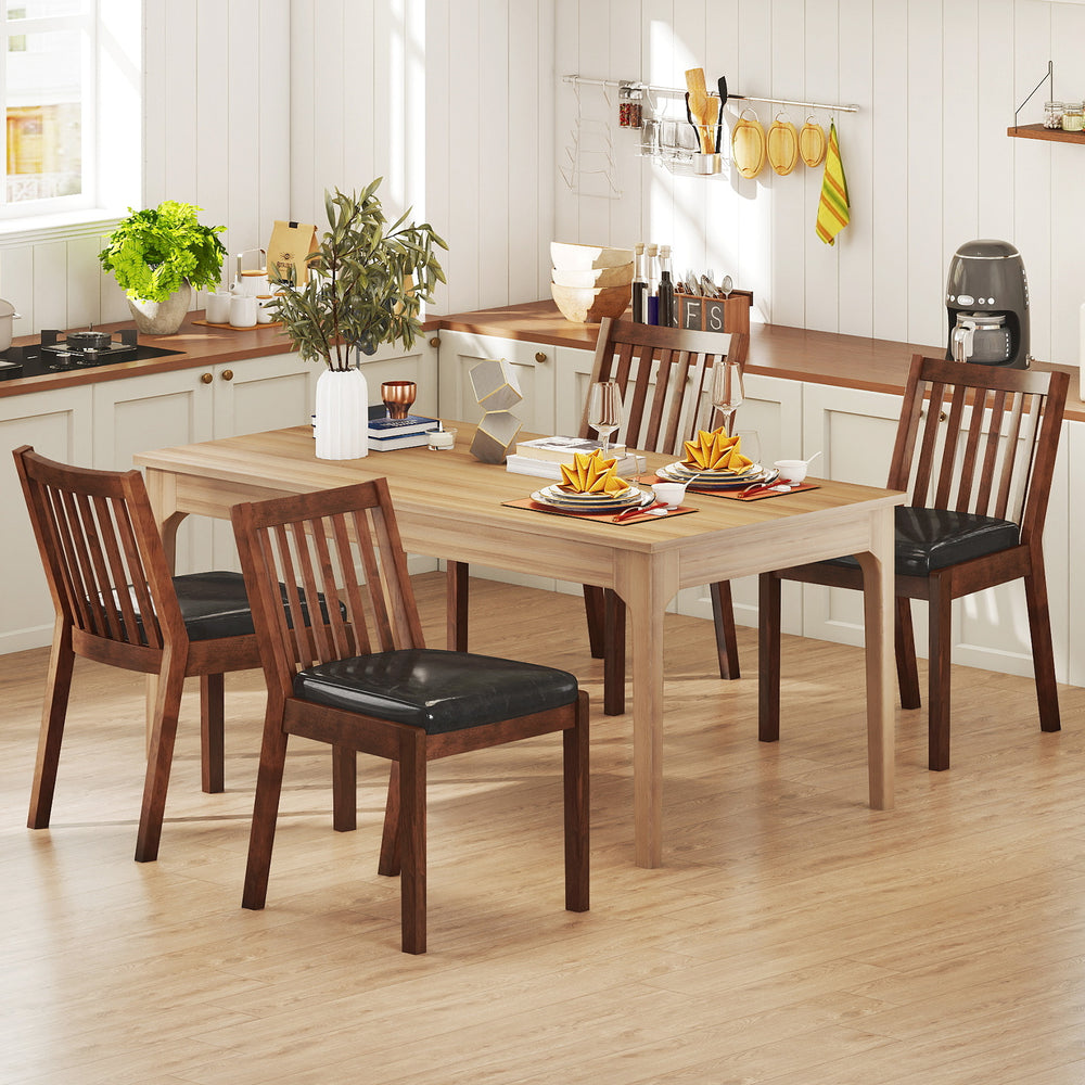 Espresso PU leather upholstered dining chairs with padded seats, arranged around a wooden dining table in a kitchen.