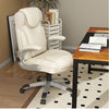 Ergonomic executive chair in cream PU leather with height adjustment, placed beside a spacious desk in a modern office.