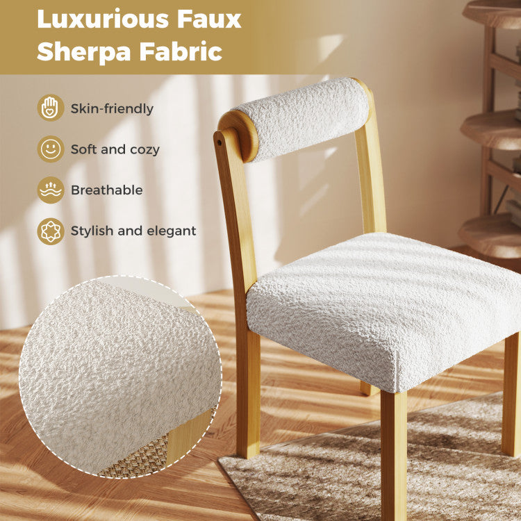 Close-up of a wooden dining chair with soft faux sherpa fabric, showcasing its stylish and cozy design.