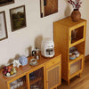 Bamboo sideboard cabinet with rattan doors and a coffee maker, showcasing rustic elegance in a modern dining room.
