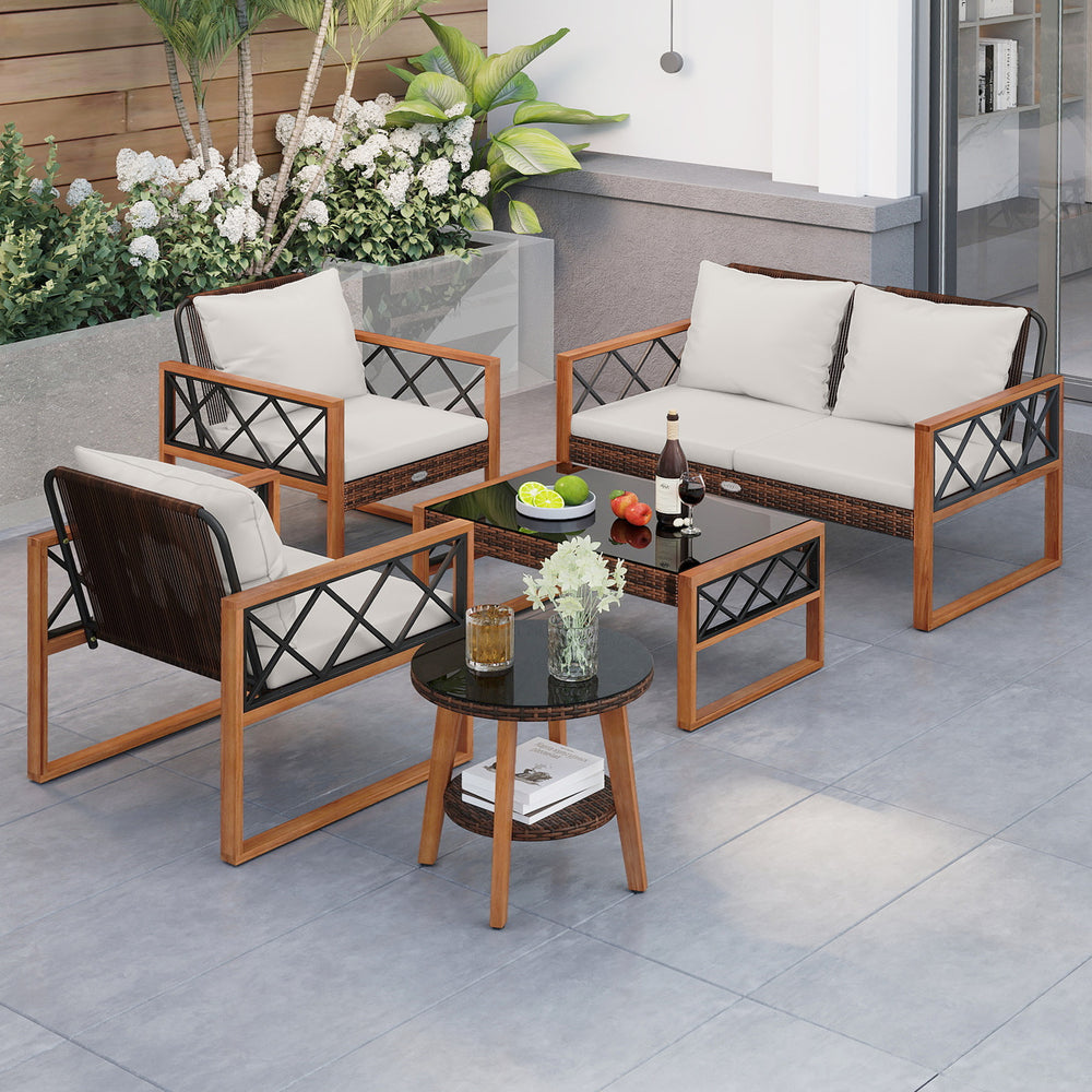 5-piece PE wicker patio furniture set with acacia wood frame, featuring cushions and two tables for outdoor relaxation.