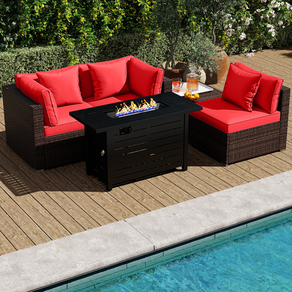 Rattan sofa set with red cushions and 60,000 BTU firepit table, perfect for outdoor relaxation by the pool.