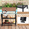 Outdoor foldable grill table with a flip-up top, sturdy metal frame, and two storage shelves for backyard use.