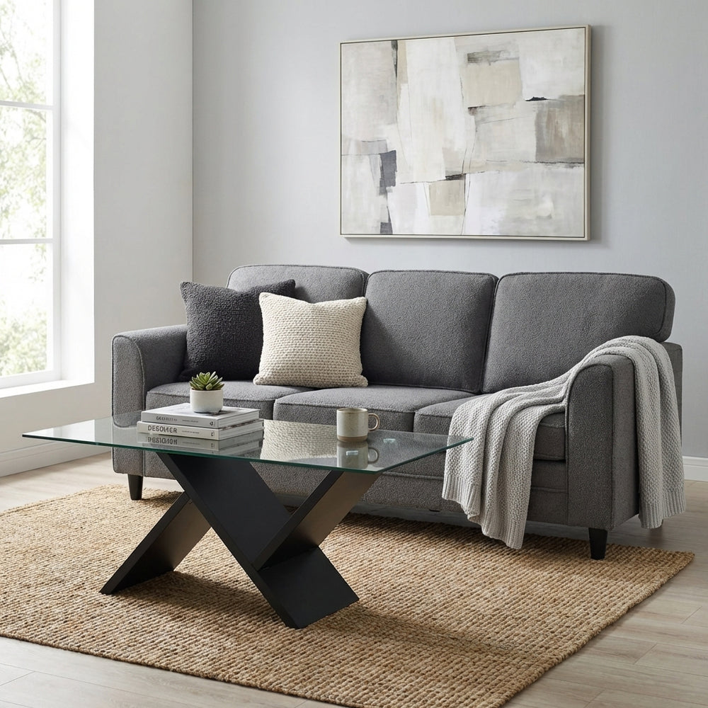 Glass coffee table featuring a sleek geometric design paired with a plush teddy velvet sofa for contemporary living.