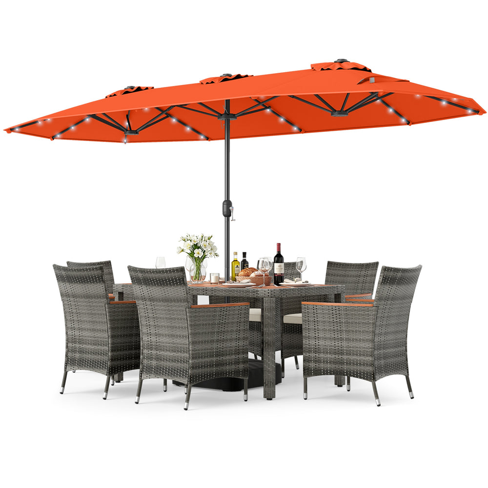Outdoor wicker dining set with orange double-sided umbrella, featuring acacia wood table and ergonomic chairs for.