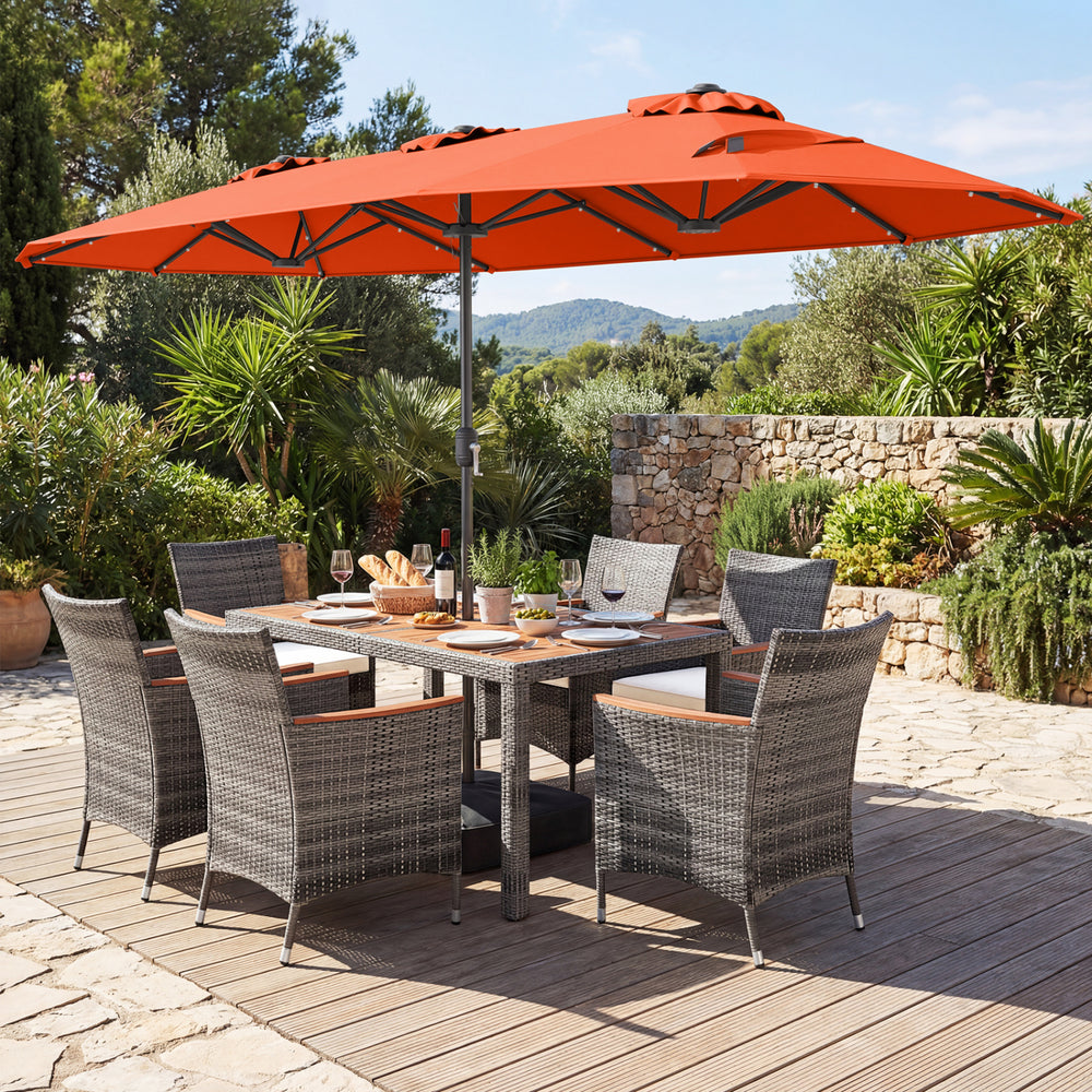 Outdoor wicker dining set with orange 13.5 FT umbrella, featuring ergonomic chairs and acacia wood tabletop for patio.