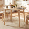 Round rubber wood dining table set with two padded chairs, perfect for kitchen or dining room use.