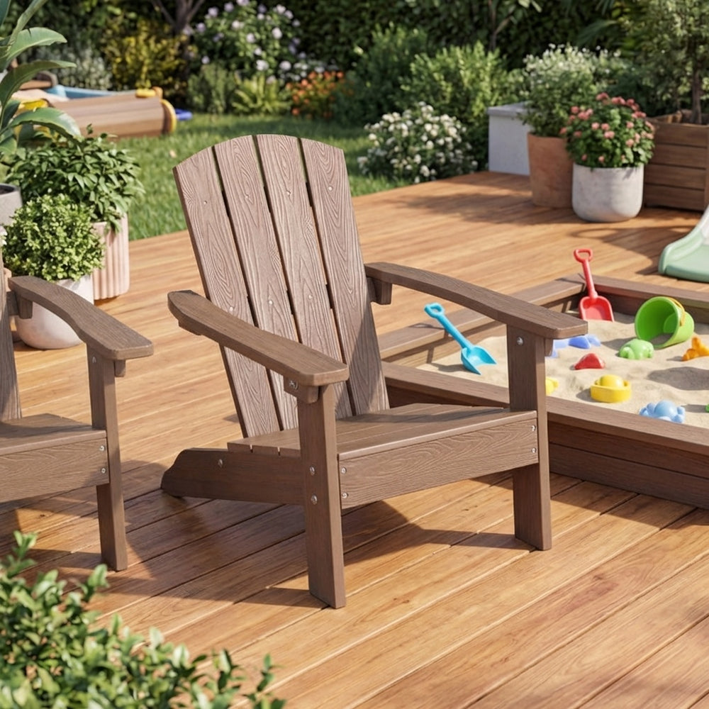 Two kid-sized Adirondack chairs in brown, perfect for outdoor relaxation next to a sandbox for children's playtime.