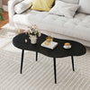 Cloud shape coffee table with a black metal frame, featuring a wide tabletop for living room organization and style.
