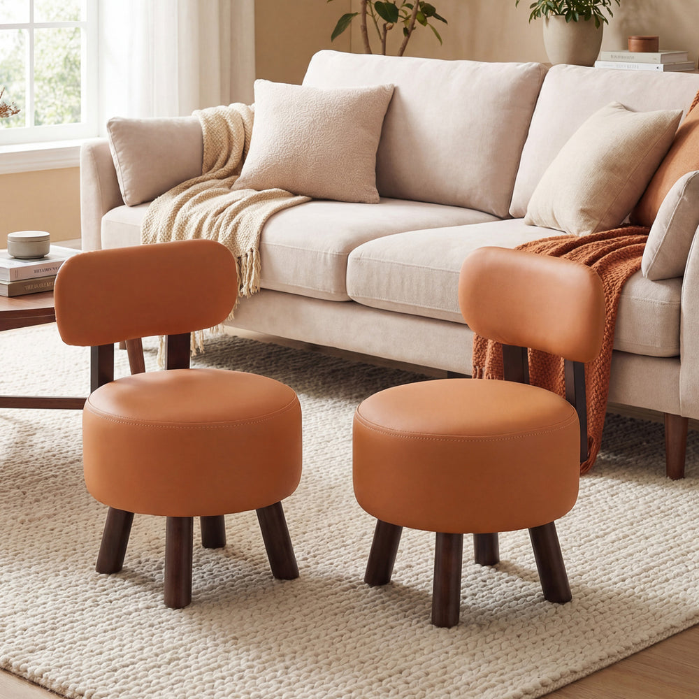 Set of 2 round orange ottomans with backrests, featuring faux leather and rubber wood legs for living room comfort.