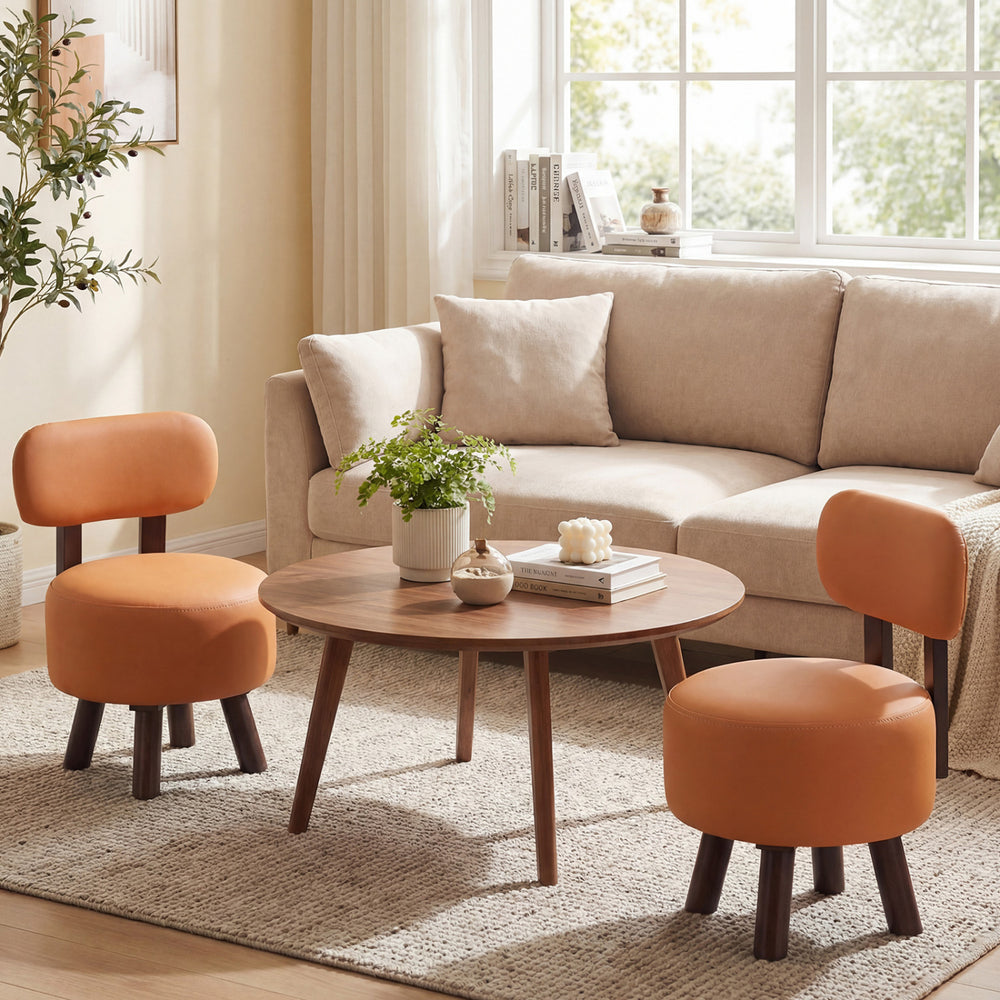 Set of 2 orange round ottomans with backrests, featuring faux leather and rubber wood legs, perfect for living rooms.