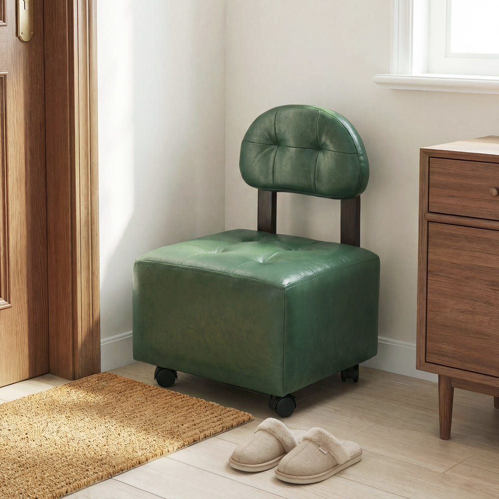 Green small rolling footrest stool with supportive backrest and lockable wheels, ideal for living rooms or bedrooms.