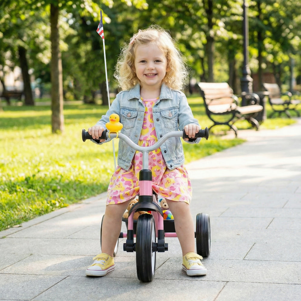 Toddler riding the Glowing Wheels foldable tricycle with basket and duck bell, perfect for outdoor fun.