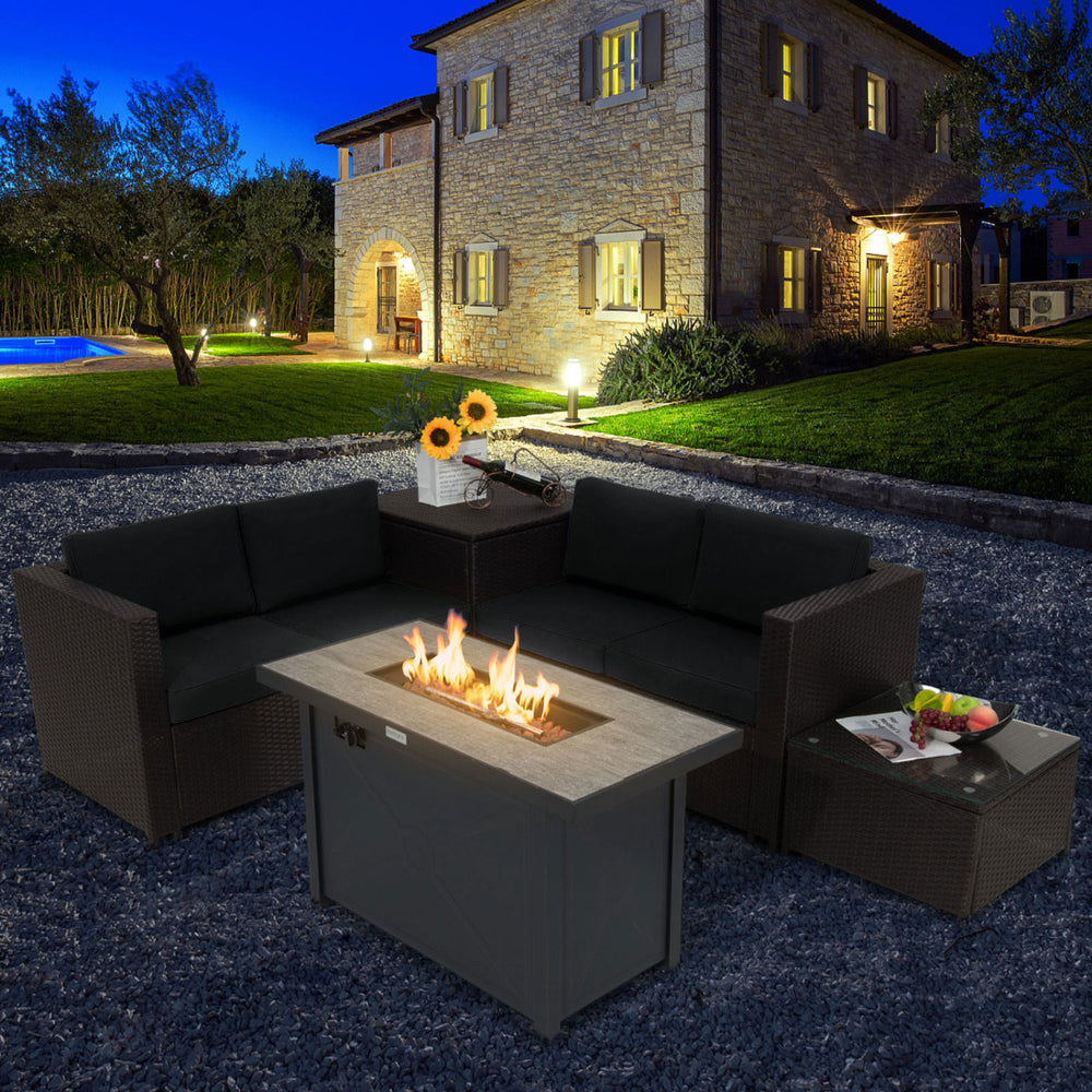 L-shaped patio sofa set with plush black cushions, accented by a propane fire pit table for evening relaxation outdoors.