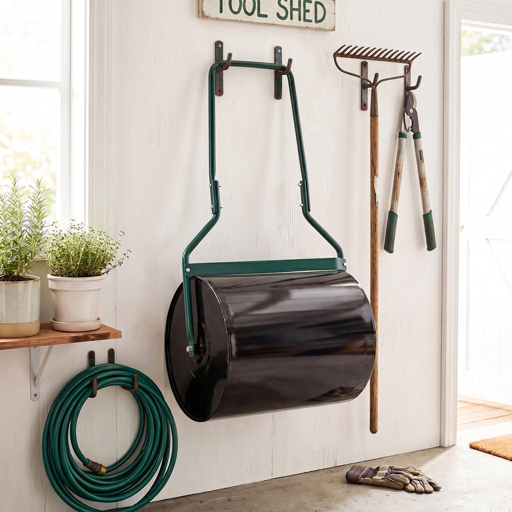 Lawn roller with a 12-gallon capacity, filled with water or sand, hanging in a garden shed for easy storage.