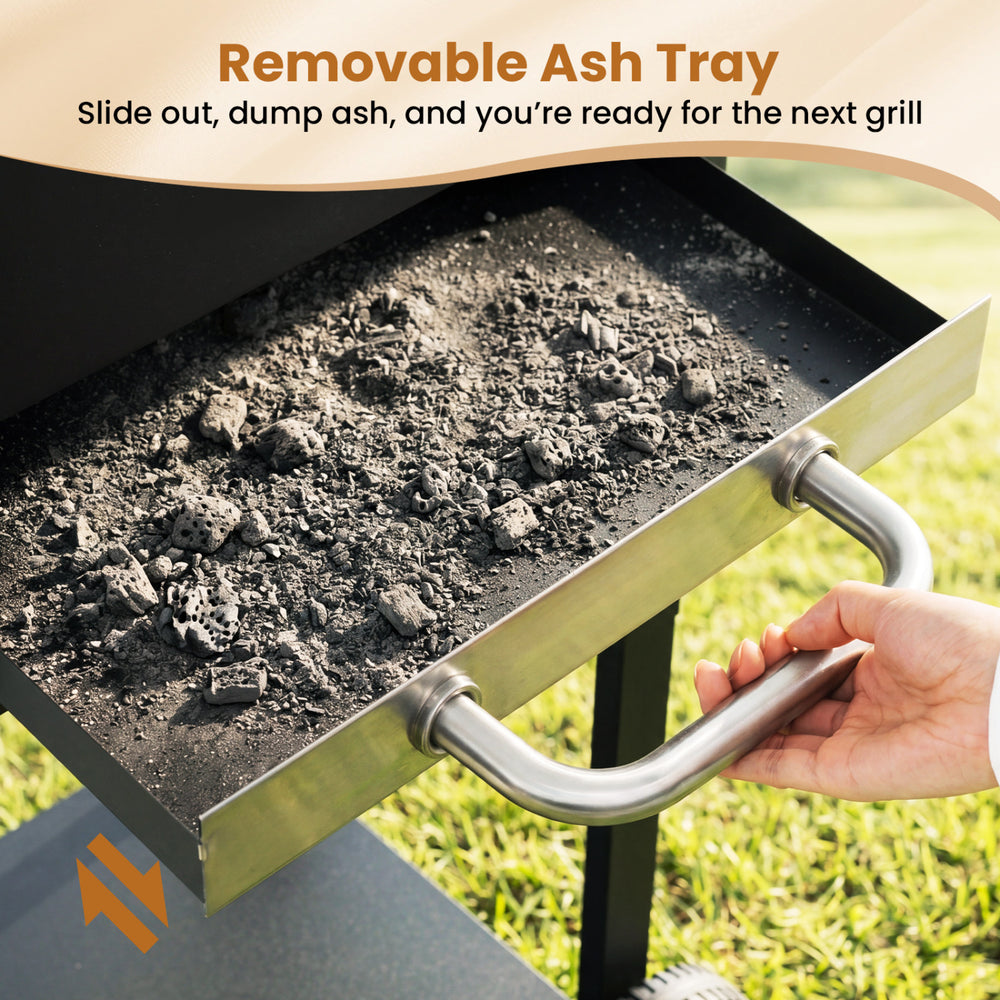 Removable ash tray of the charcoal grill for easy cleanup, featuring a sturdy handle for convenient dumping.