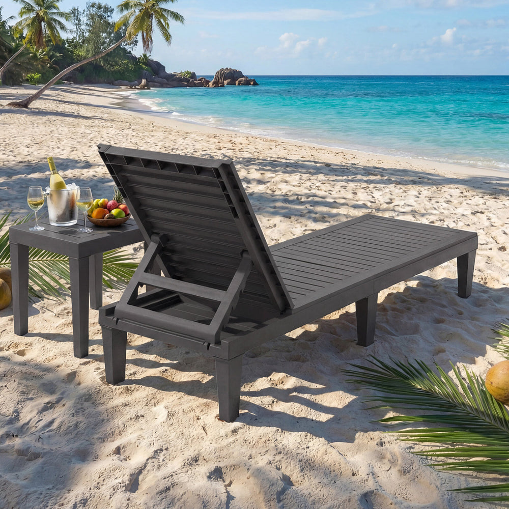 Gray outdoor chaise lounge chair with adjustable backrest on the beach, ideal for relaxing by the poolside or garden.